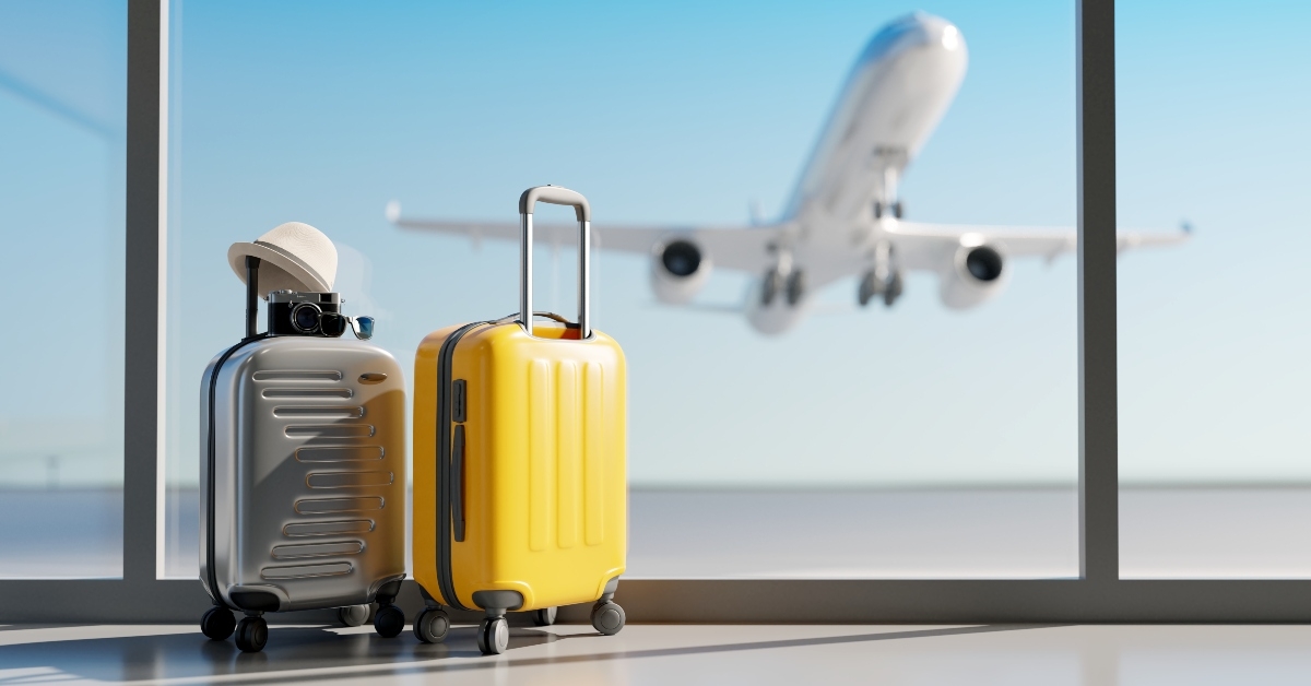 suitcases with airplane in background 