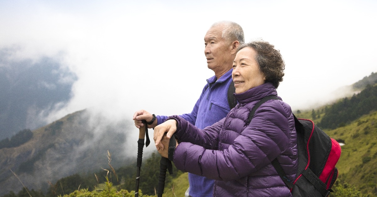  senior couple hiking on the mountain