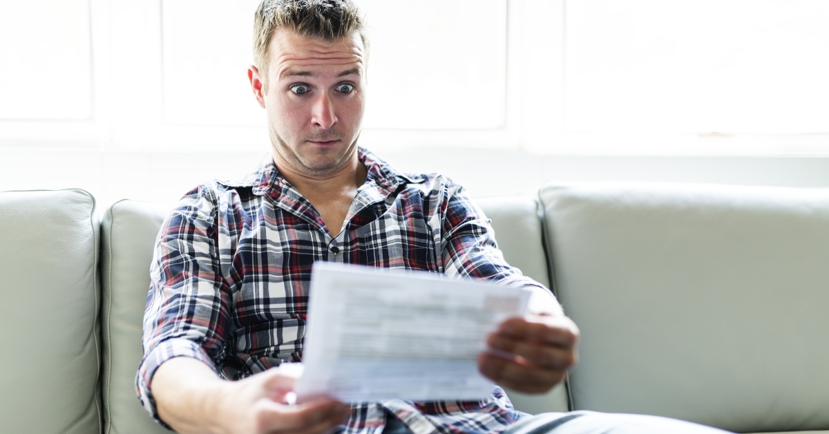 Surprised man looking at bill