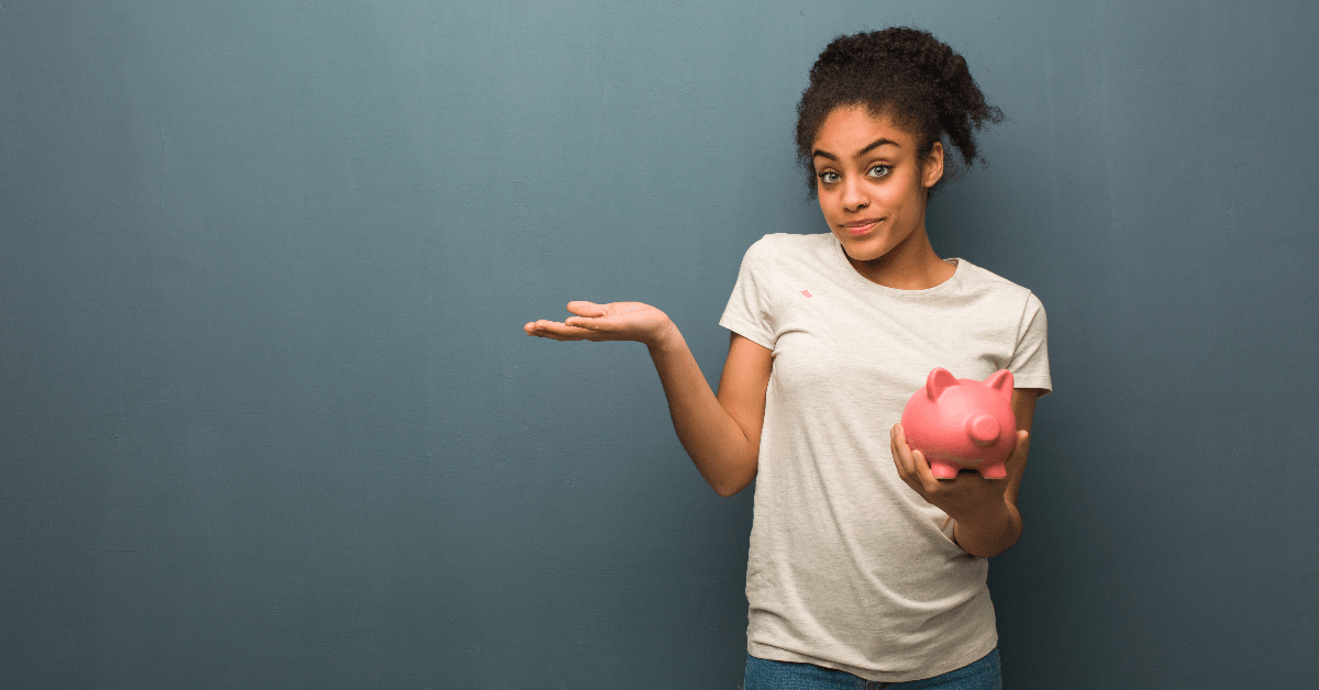 Woman shrugging holding piggy bank