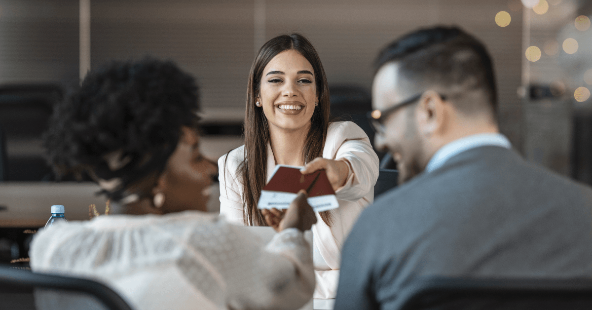 Travel agent handing passports to clients