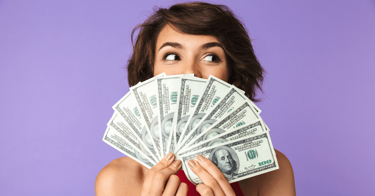 happy woman holding cash