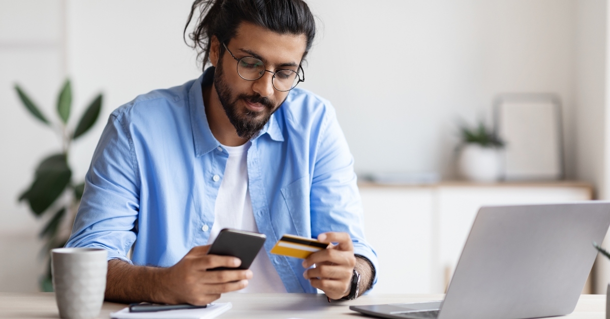 Man holding credit card and phone
