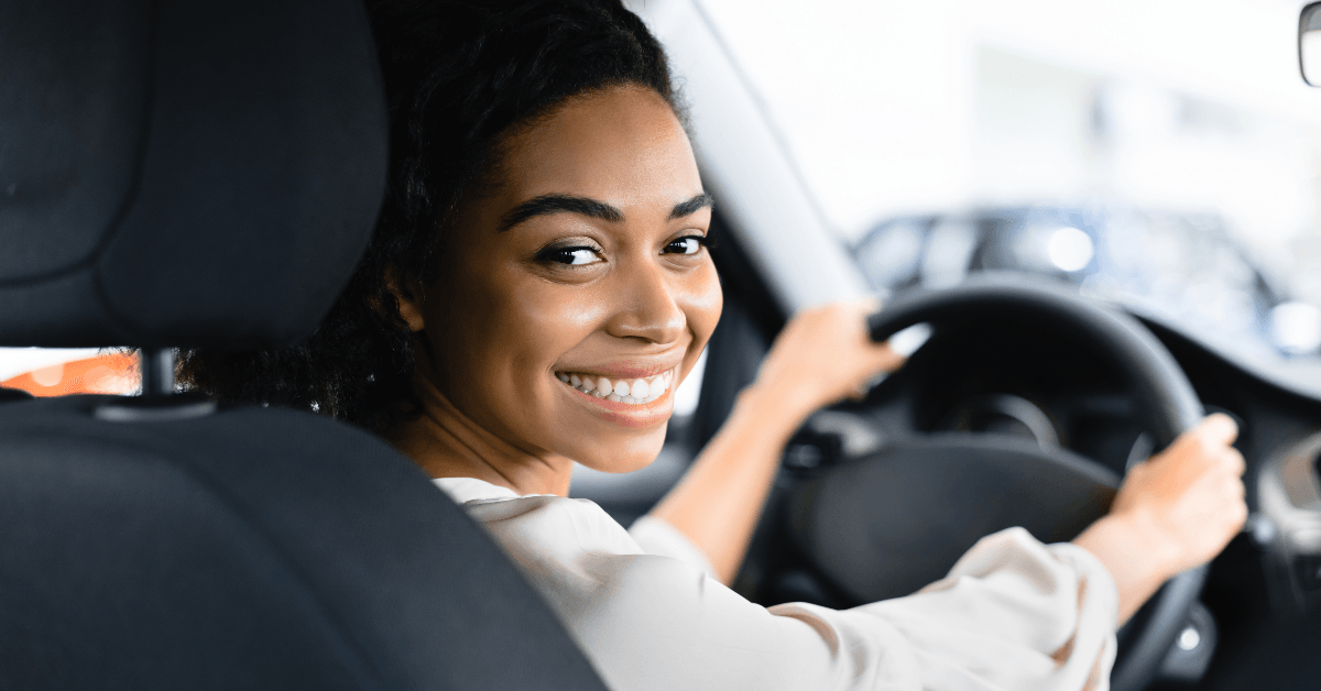 smiling woman driving car
