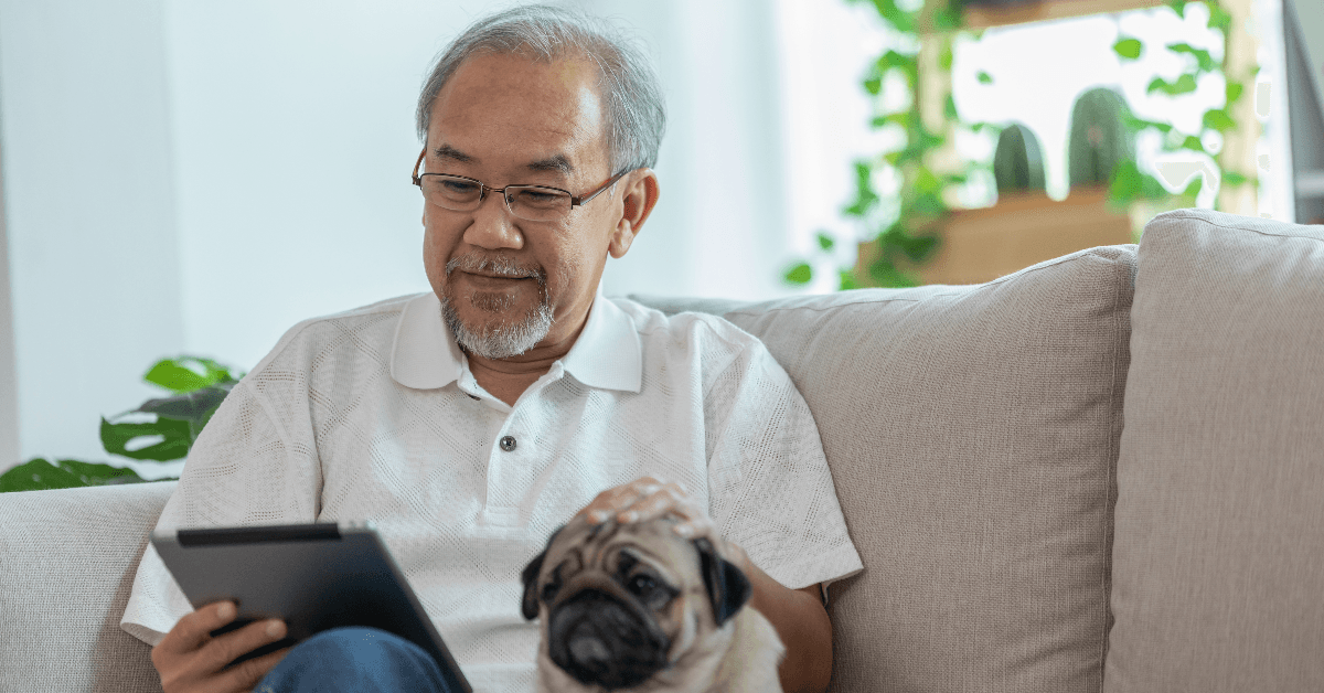 Senior man on couch with dog