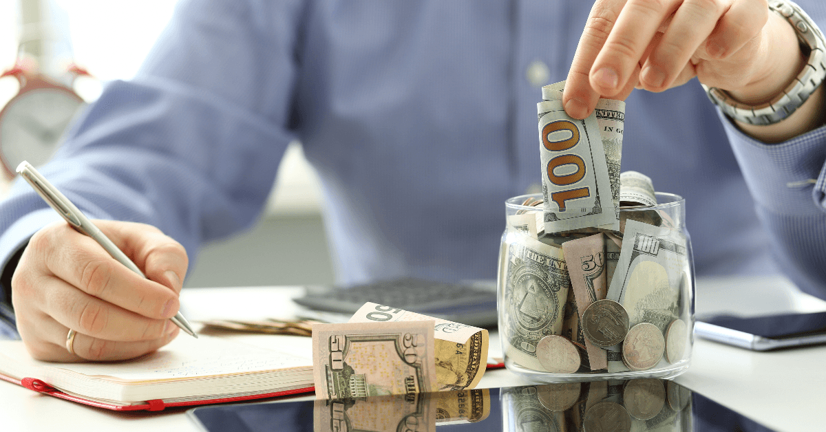 Person putting cash in an emergency fund