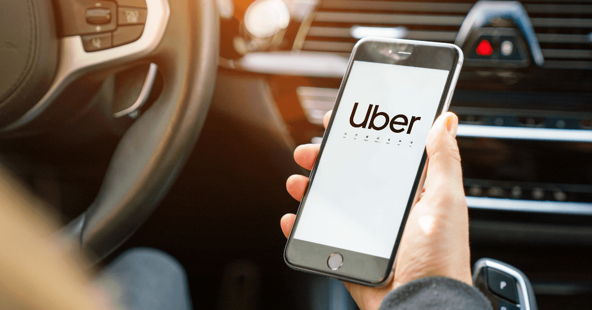 Person holding phone looking at uber app
