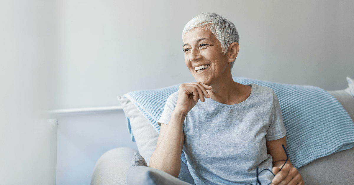 Happy woman sitting on couch