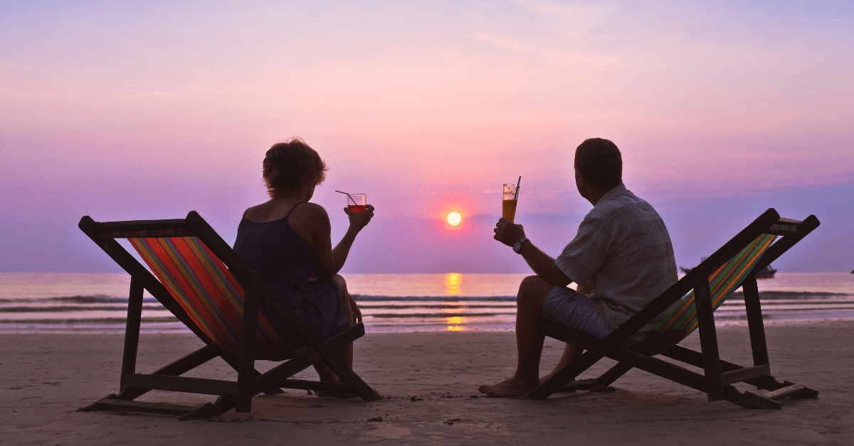 Retired couple sitting at the beach