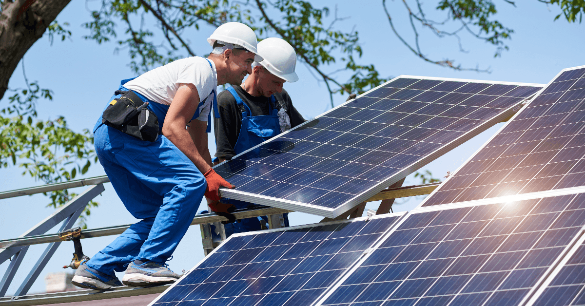 Two men installing solar panels