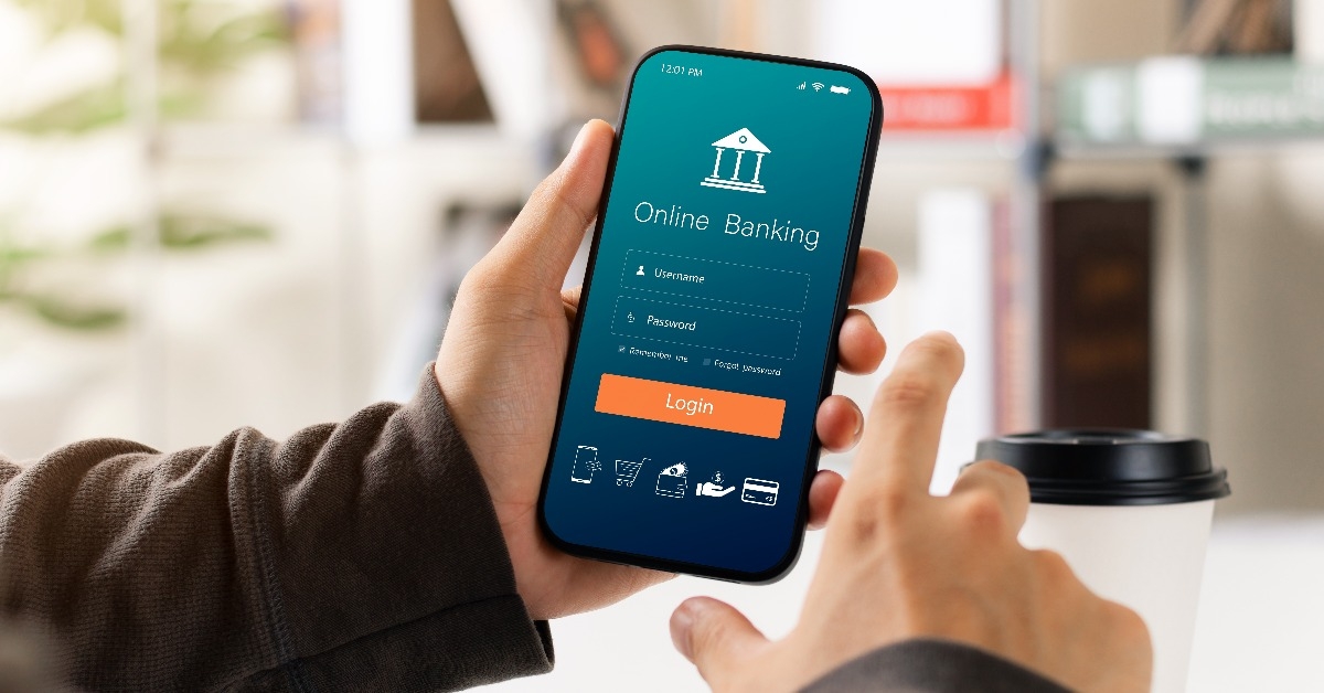 male executive using smartphone to conduct online mobile banking