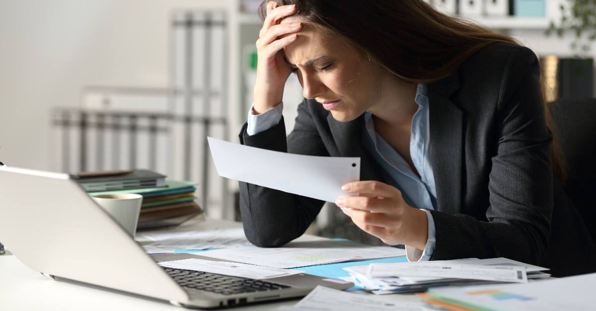 sad executive complaining holding receipt at night at office