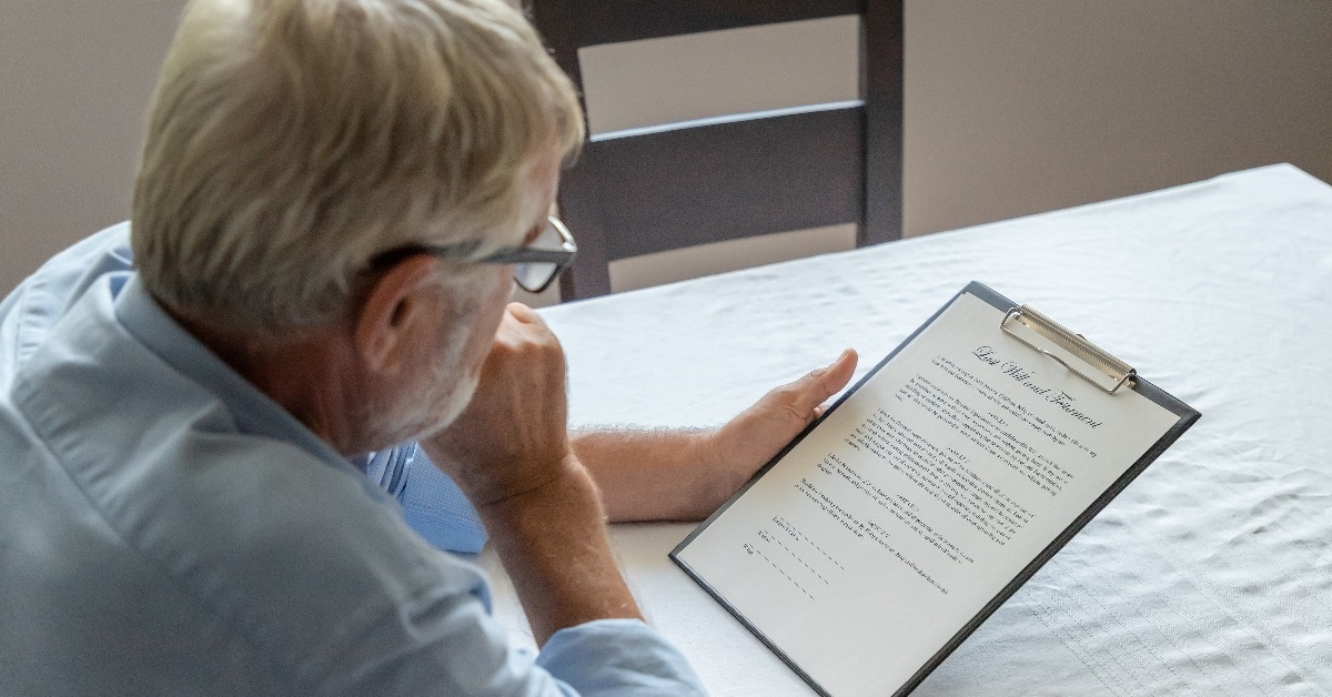 Senior old man elderly examining and checking last will and testament