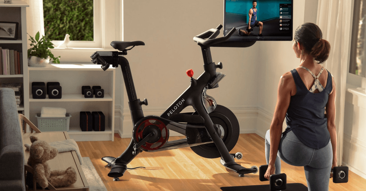 Woman working out at home with a Peloton bike