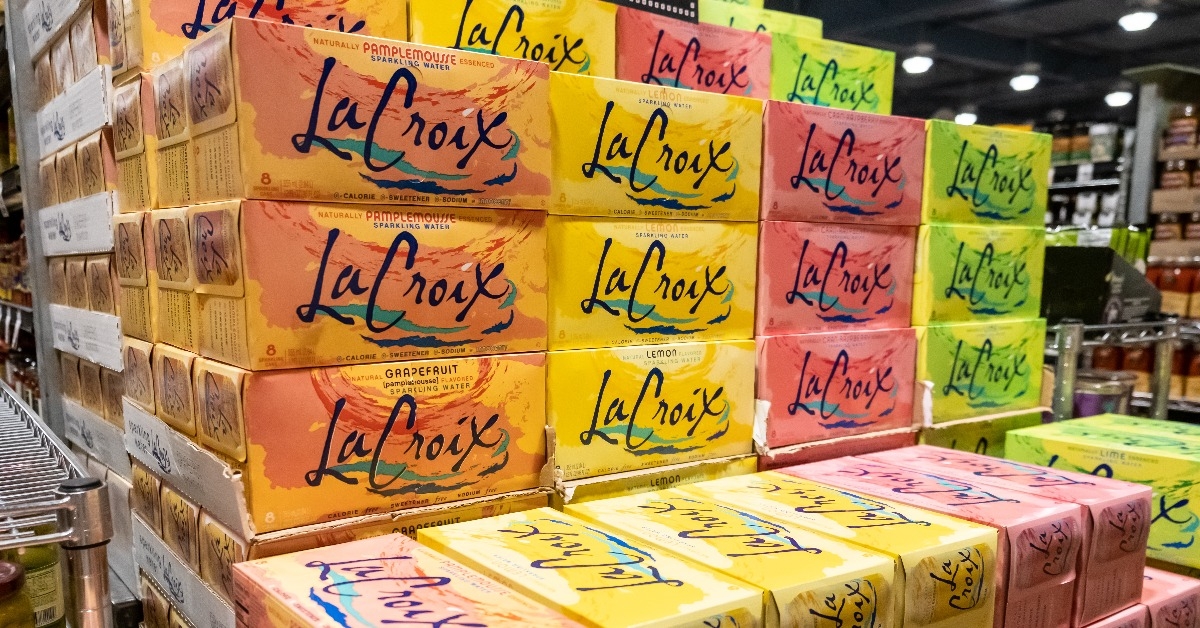 pile of assorted cases of La Croix brand fruit flavored sparkling water