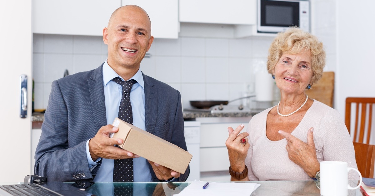 agent showing box to woman