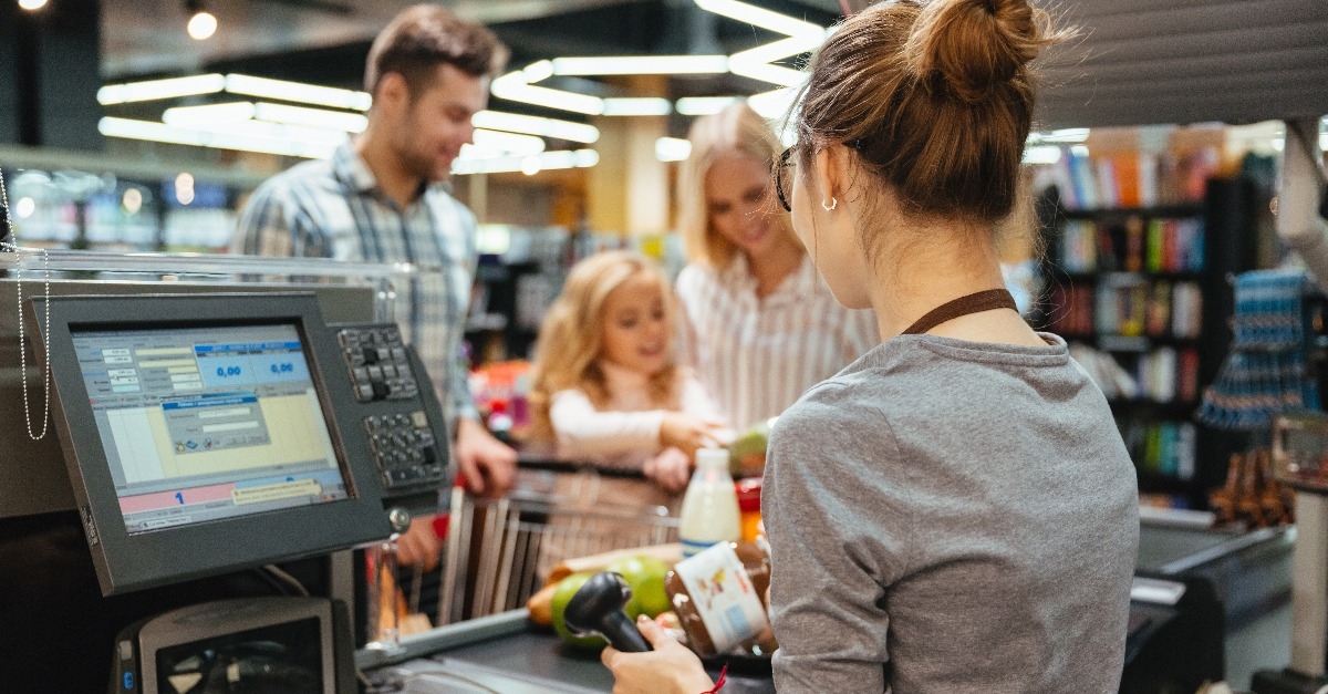 beautiful family standing at the cash counter