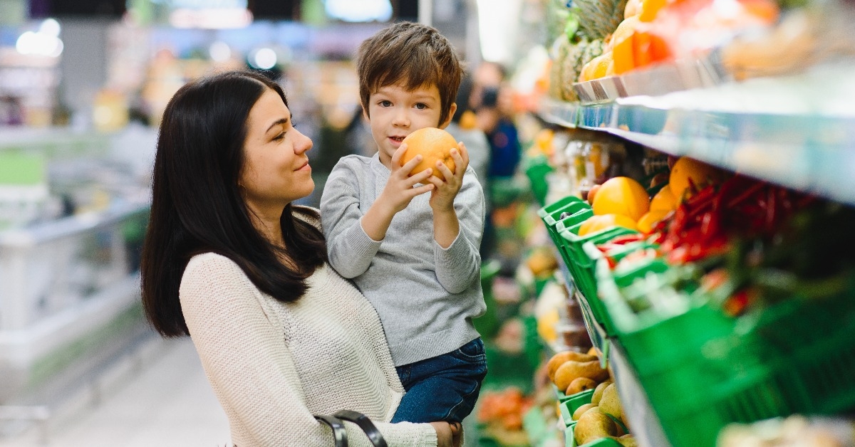 young mother with her little baby boy at the supermarket