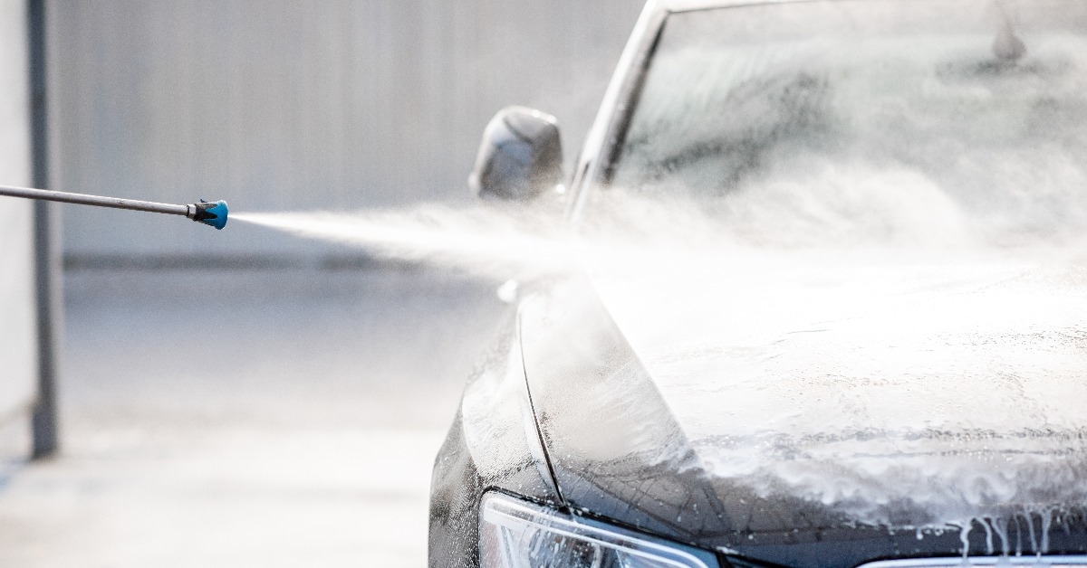  car under the water jet during the washing process 