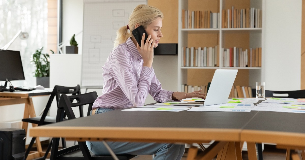 hardworking sales manager talking to client on cellphone