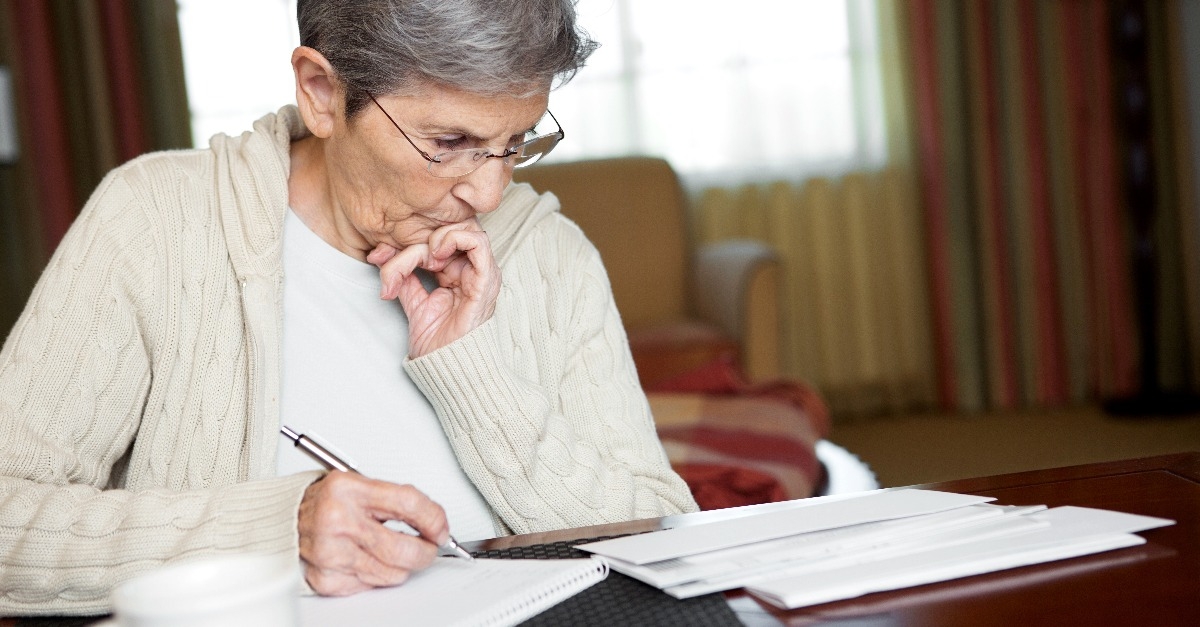 senior woman working on her bills