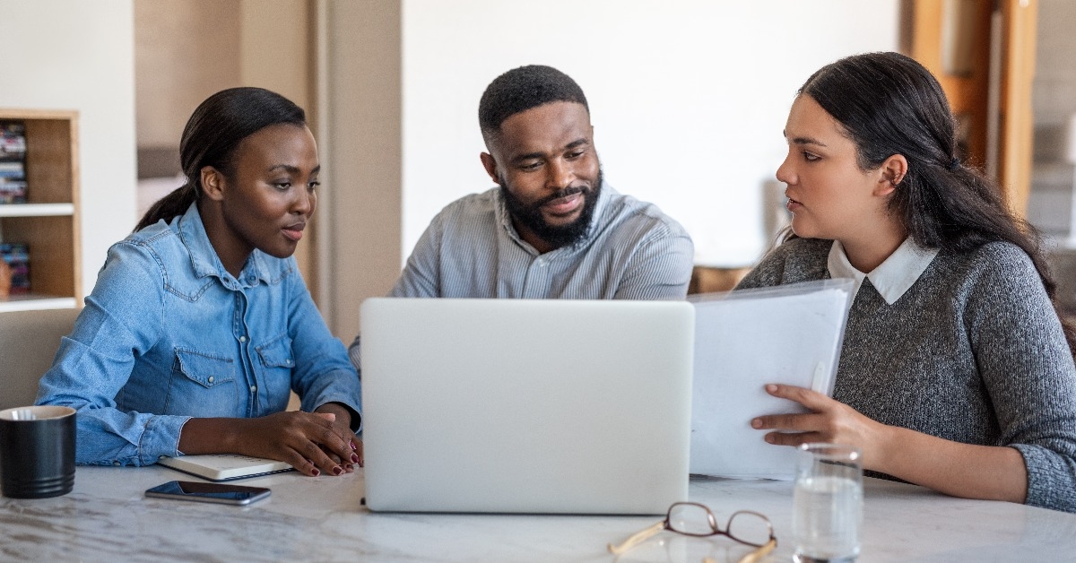 African American couple talking to their financial advisor at home