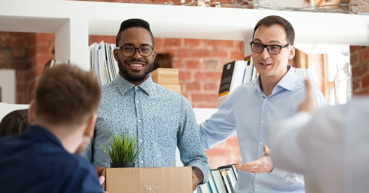 african man having first working day getting acquainted with colleagues