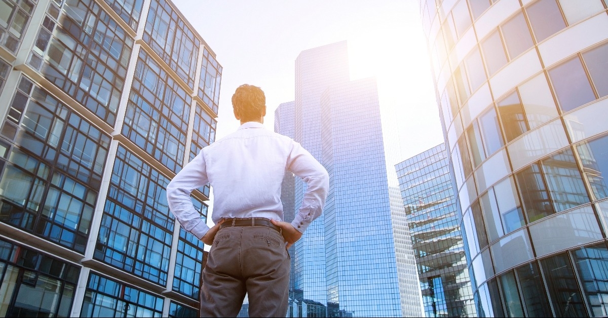 man looking at office buildings