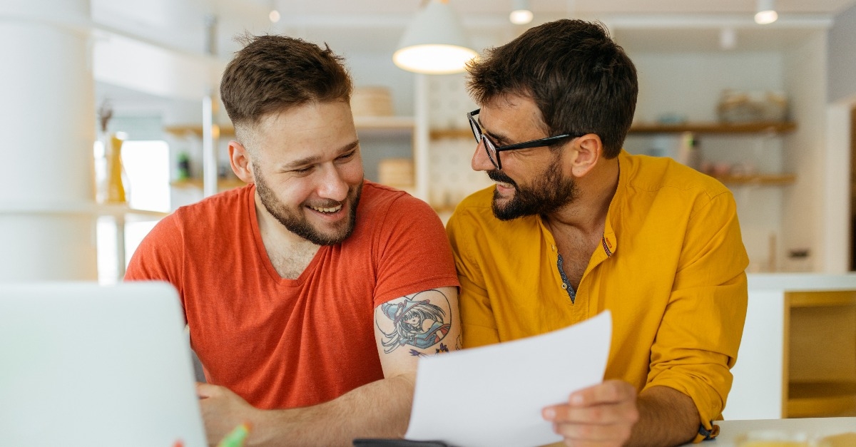 gay couple calculating their monthly income