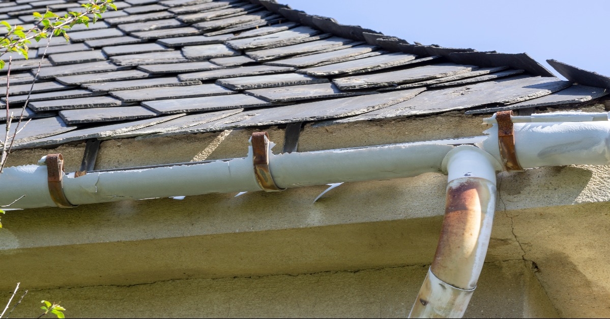 a broken gutter on the roof of a house