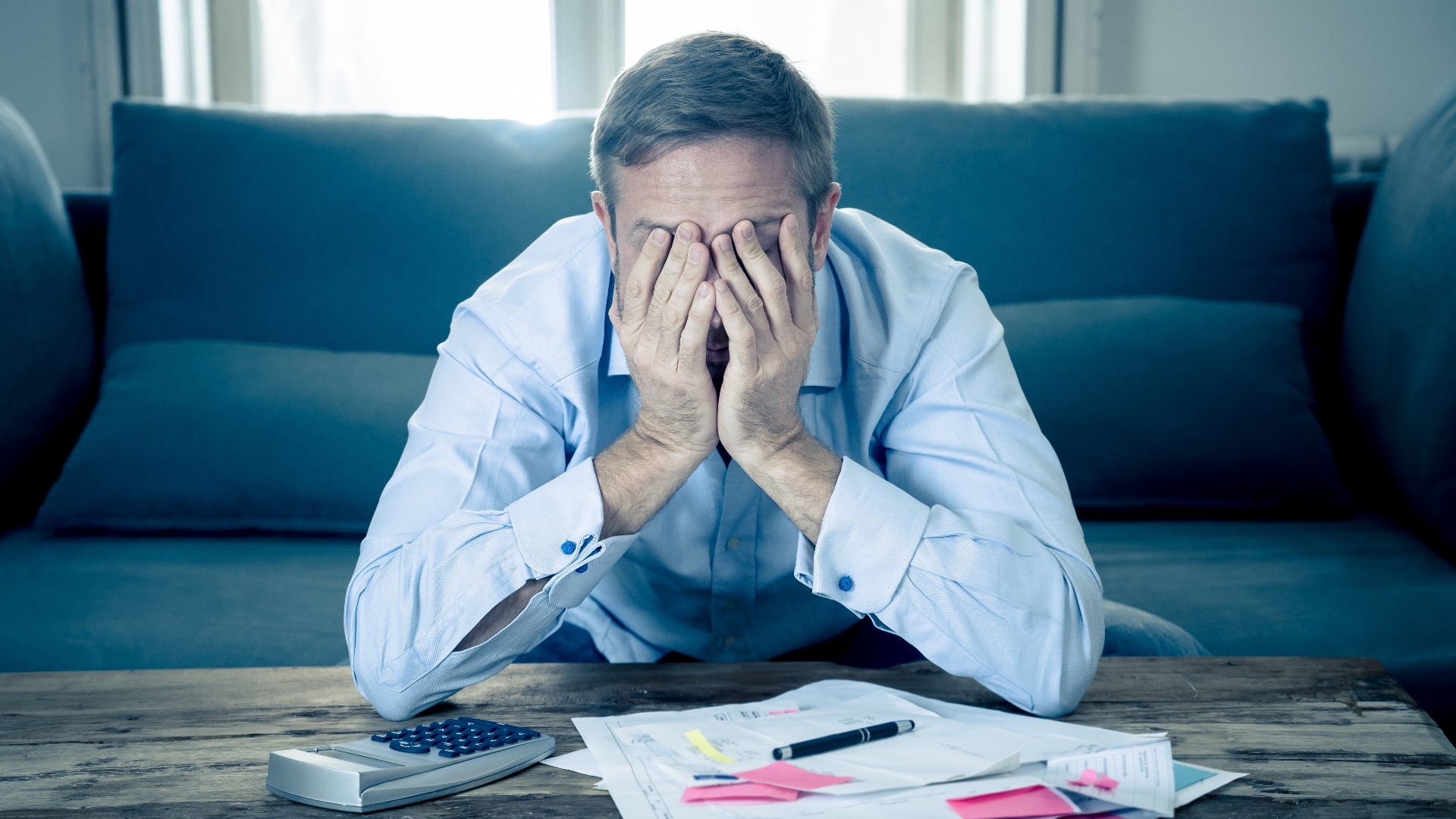 upset man in stress paying bills