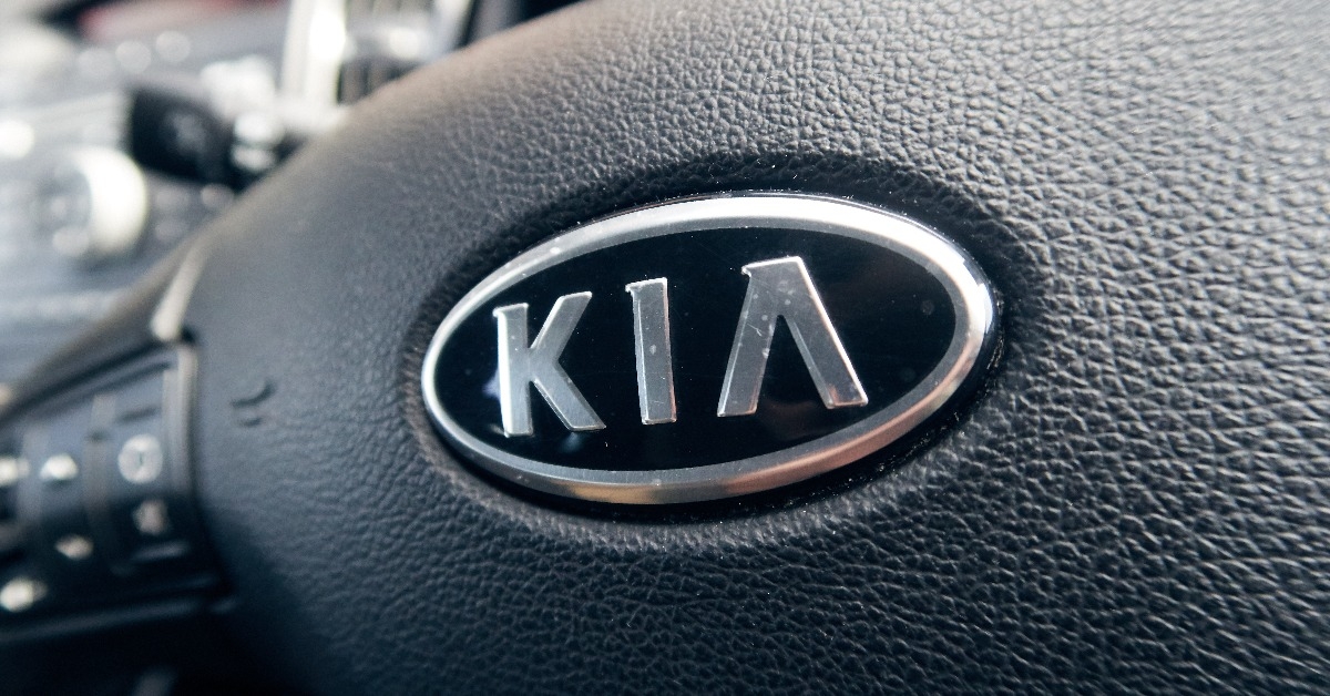 A steering wheel with a kia car brand logo