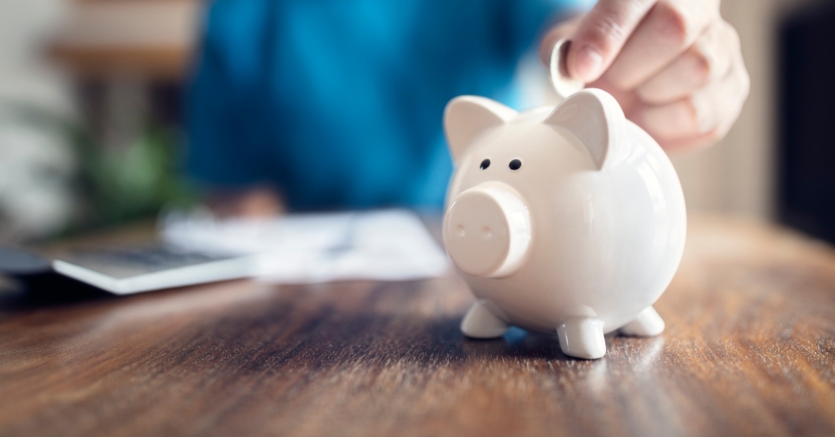 piggy bank with a coin placed in it