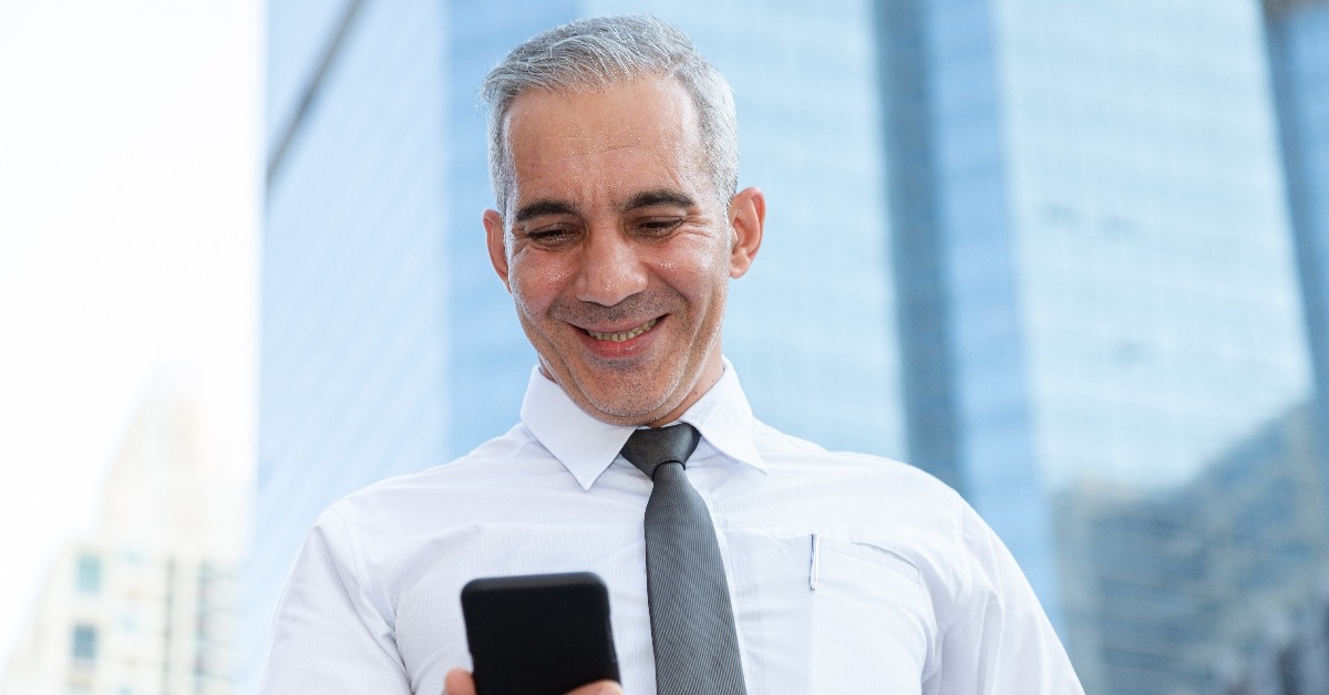 businessman happy after checking profit on investment portfolio