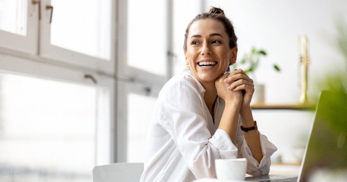 creative young woman working on laptop in her studio