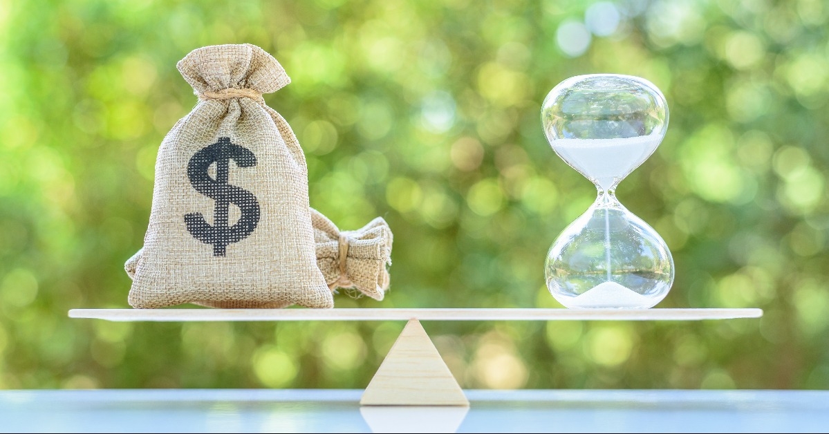 dollar bags sand clock or hourglass on a balance scale in equal position