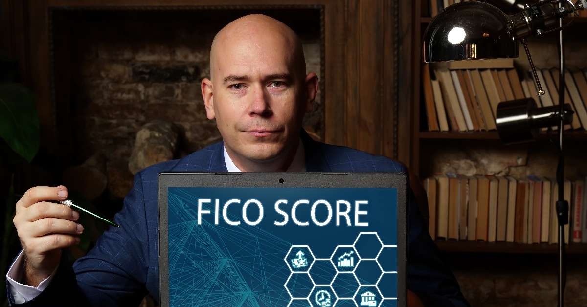 financial concept meaning FICO SCORE with phrase on the laptop