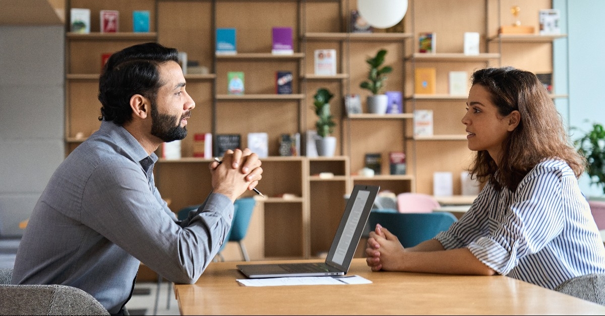 boss listening to a female latin candidate at job interview