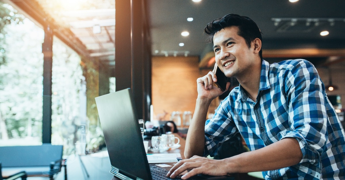 asian man working on computer touch pad