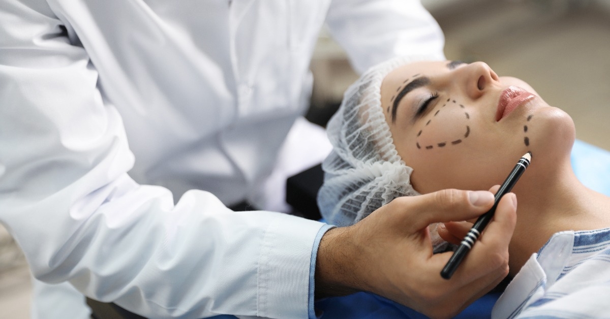 doctor preparing female patient for cosmetic surgery in clinic