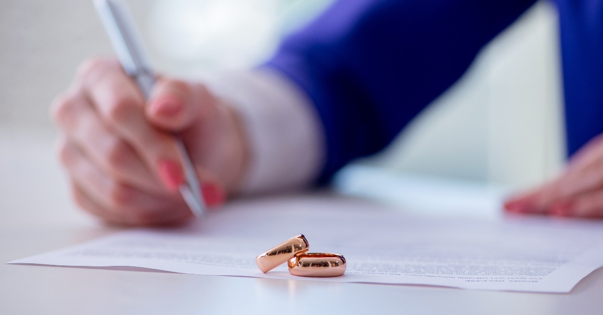 woman signing prenuptial agreement in court
