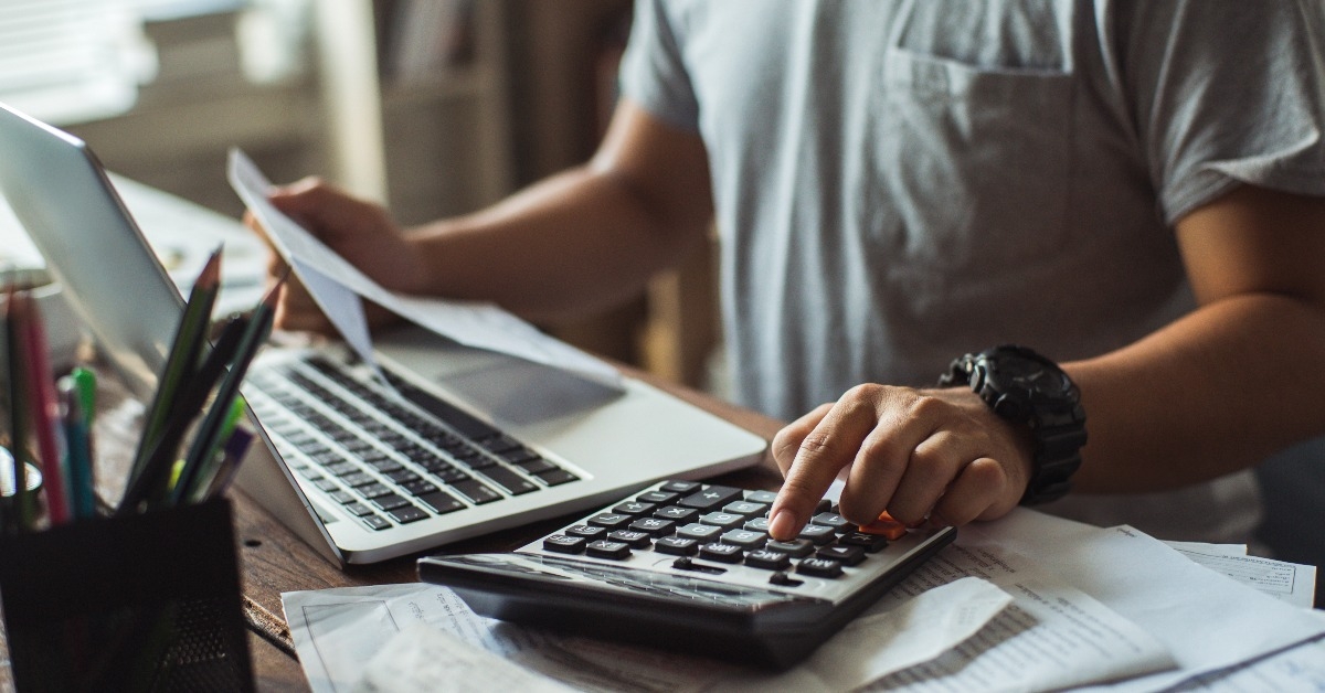 man is calculating the cost of the bill