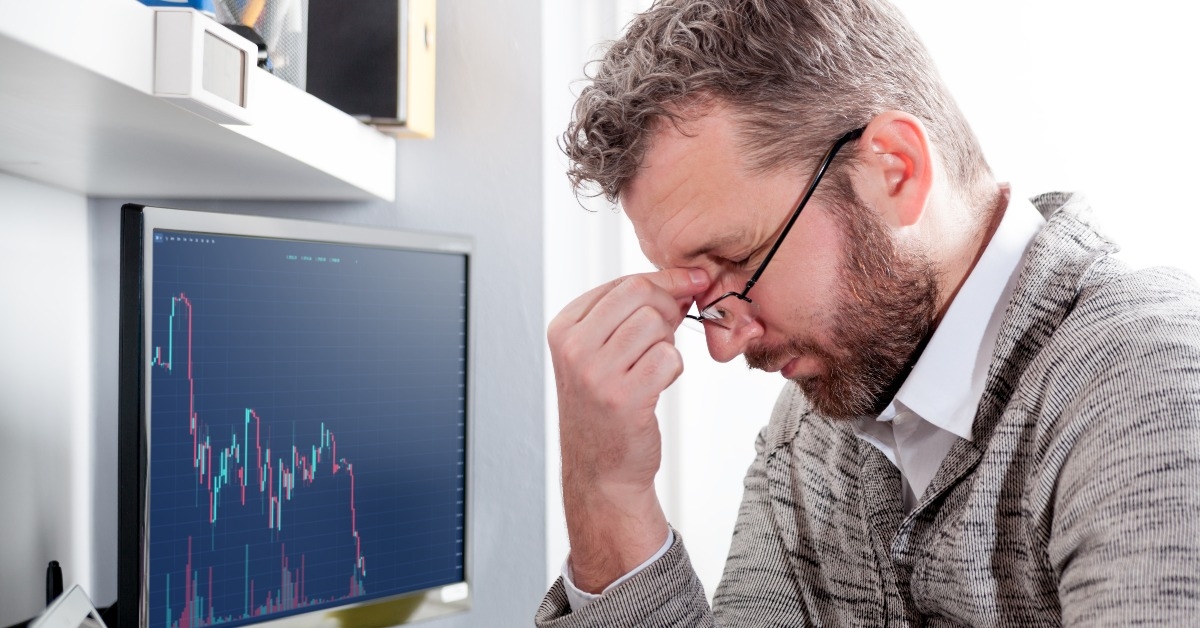 depressed investor analyzing crisis stock market
