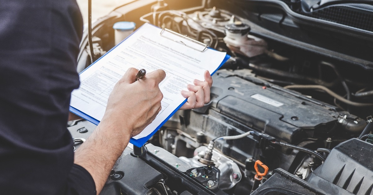 automobile mechanic repairman checking a car engine