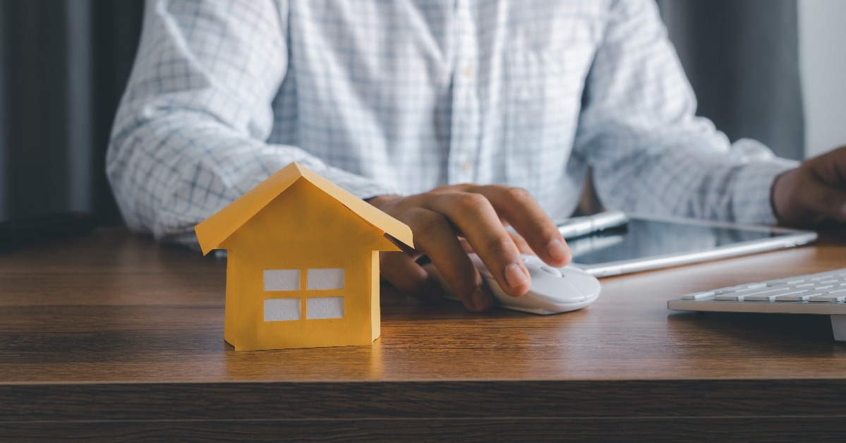paper house model with young asian man