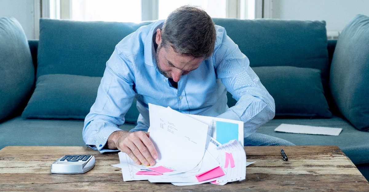 Upset man in stress paying bills