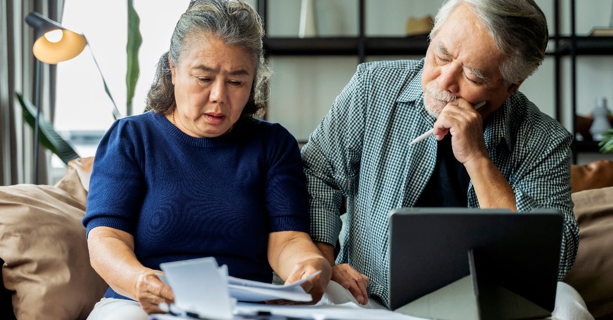 Serious stressed asian senior old couple worried about bills