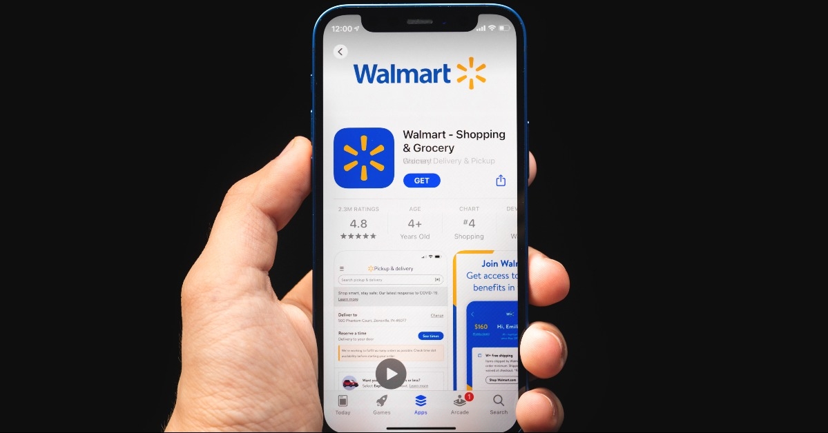 Man hold mobile phone with Walmart app