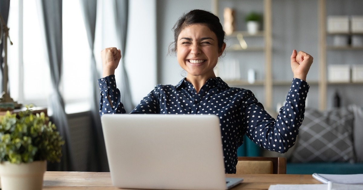 Euphoric young indian girl celebrate online victory