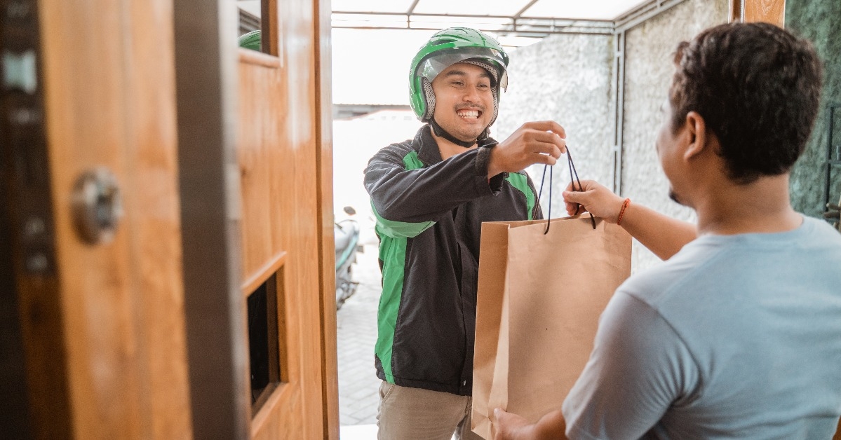 man delivery service uber send shopping bag to customer at home
